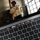 The Touch Bar, being used to scroll through photos.